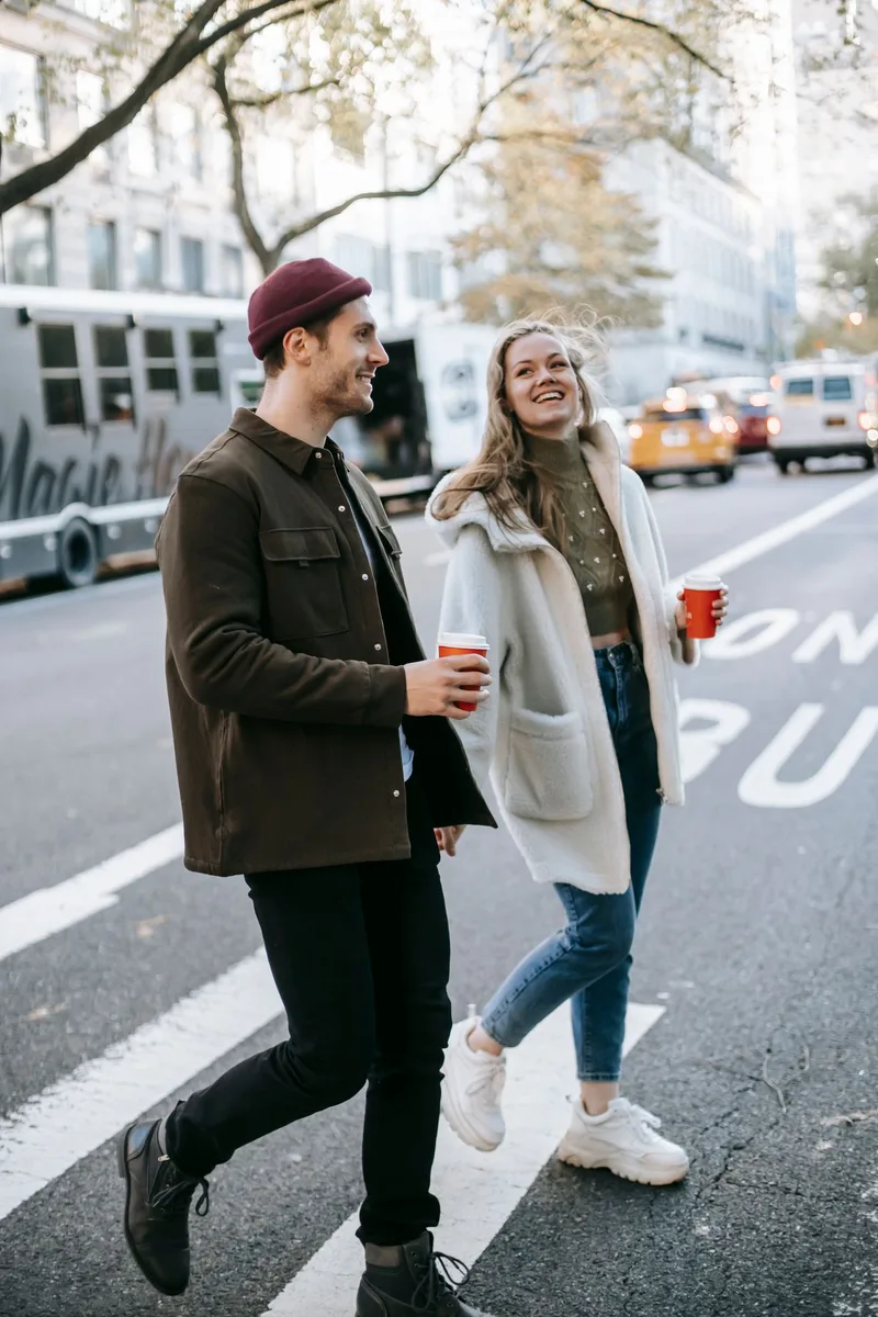 A couple walking together and talking on a city street